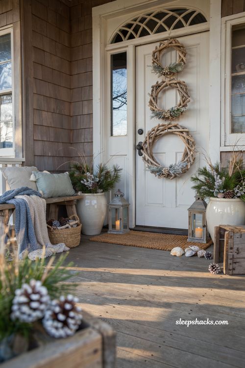 Coastal christmas porch decor ideas with stacked sun bleached wreaths on a seaside front door
