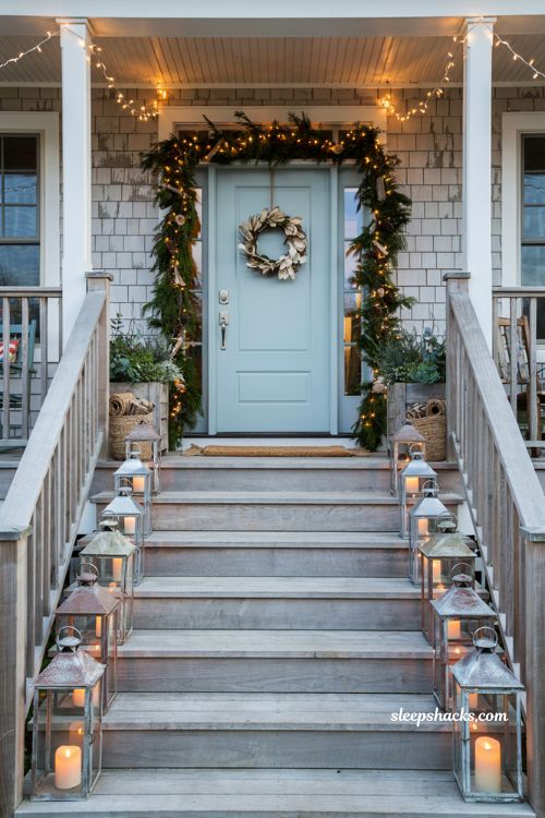 Coastal christmas porch decor ideas with weathered nautical lanterns along front steps