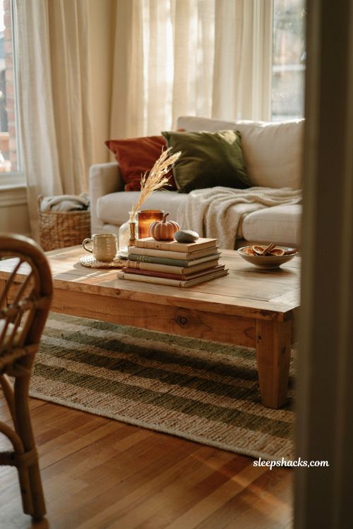 Coffee table book styling ideas for a cozy fall living room with warm decor