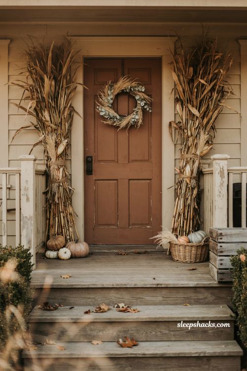 Cornstalk porch fall decor with dried cornstalk bundles jute twine wheat stems pumpkins and rustic farmhouse entry 