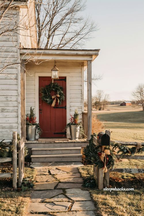 Country christmas porch with decorated farmhouse mailbox and matching holiday garland