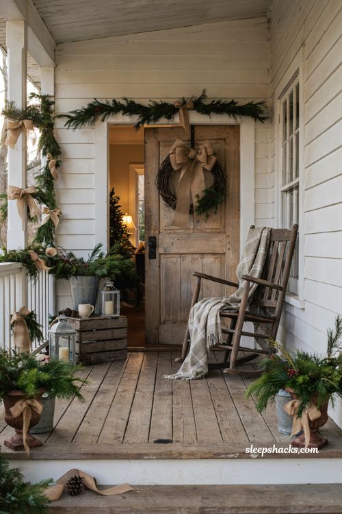 Country christmas porch with rustic burlap bows and farmhouse holiday greenery