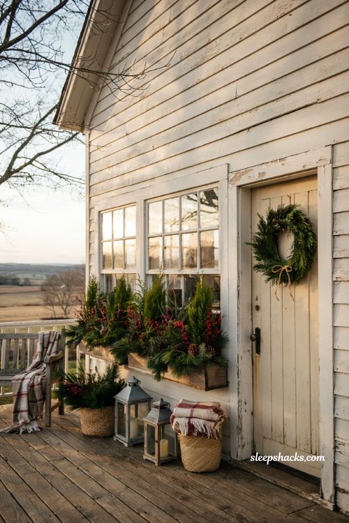 Country christmas porch with window boxes filled with evergreen branches and red berries