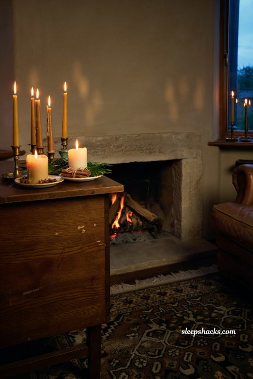 Cozy and inviting christmas candlelit living room nook with cedar and cinnamon accents