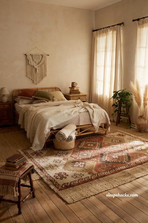 Cozy bohemian bedroom with layered kilim rug over natural jute rug