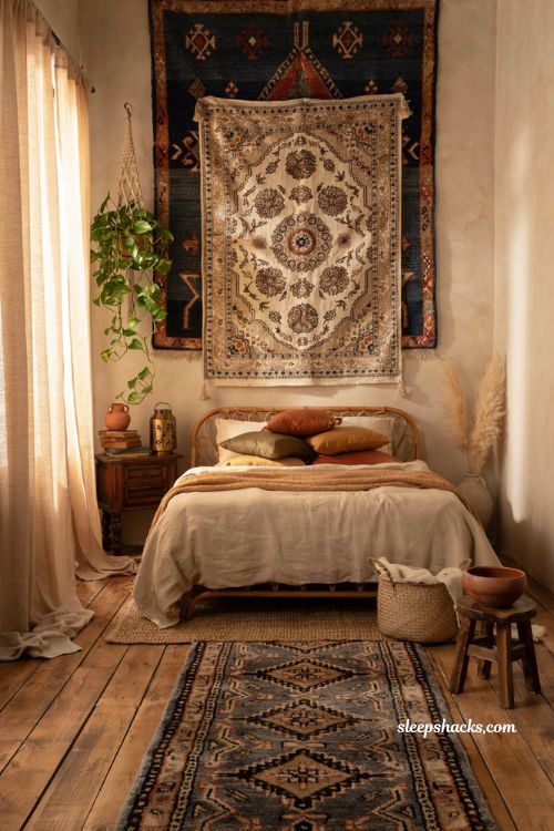 Cozy bohemian bedroom with woven tapestry and vintage Suzani wall hanging