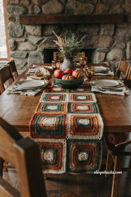 Cozy cabin crochet table runner with cream rust brown and forest green log cabin pattern rustic fall dining table
