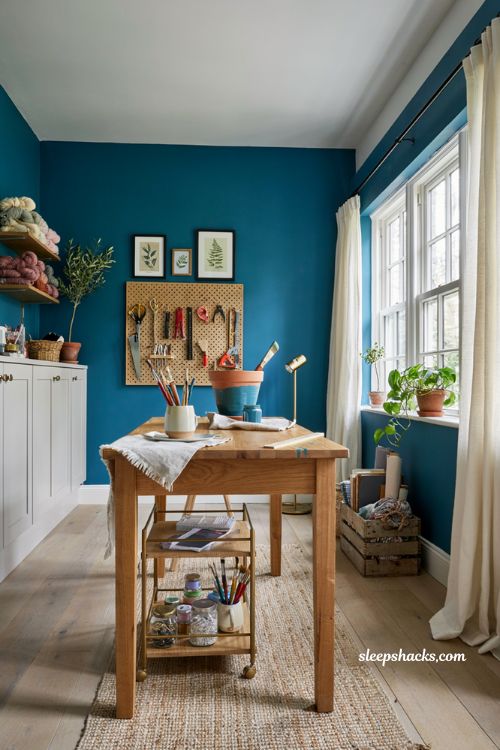 Craft room ideas with bold colorful walls and organized creative workspace