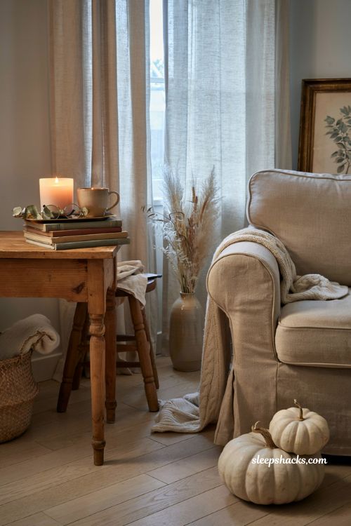 Creamy pumpkin and vanilla bean candle styling for a cozy autumn living room reading corner