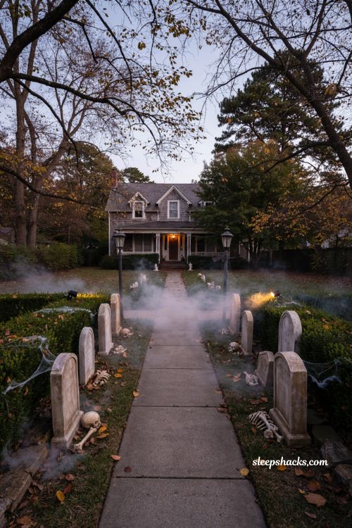 Creepy Halloween decorations with fog machine uplighting and haunted graveyard walkway 