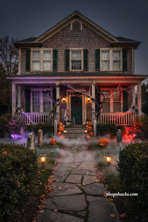 Creepy Halloween decorations with purple red spotlights fog and eerie front porch lighting 