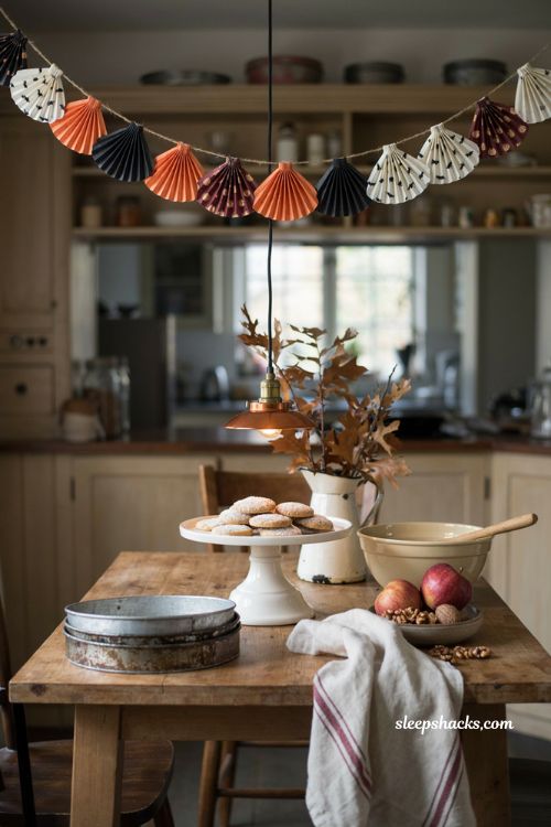 Cupcake liner Halloween garland DIY with orange black paper fans and twine