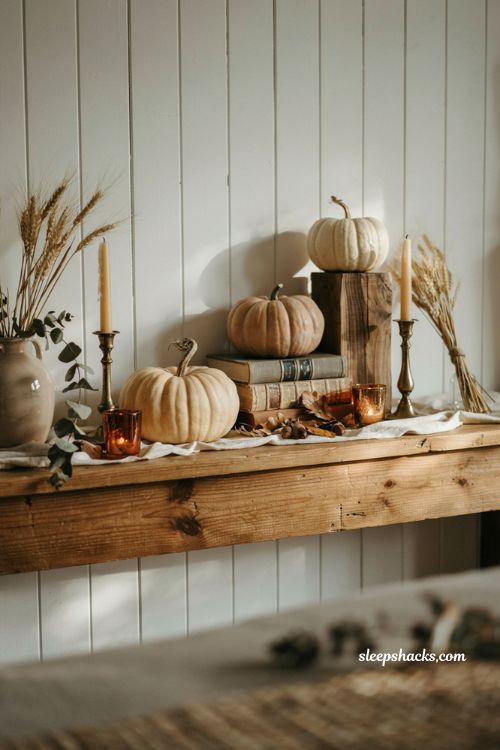 Cute pumpkin decorating ideas with three neutral faux pumpkins on a cozy farmhouse mantel