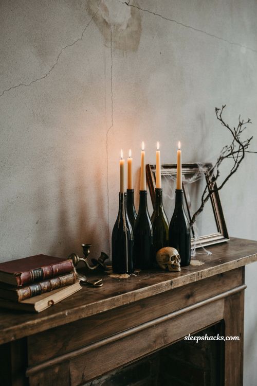 DIY creepy candle holders made from black painted wine bottles for Halloween decor 