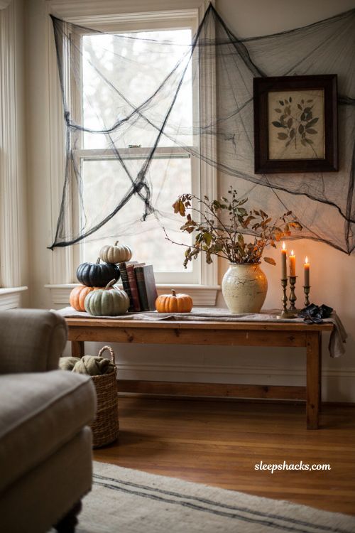 DIY trash bag spiderweb Halloween decoration for a cozy living room