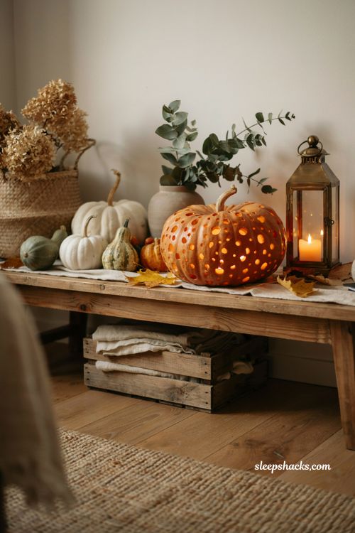 Diffused polka dot pumpkin carving idea with glowing drilled pattern for elegant fall decor