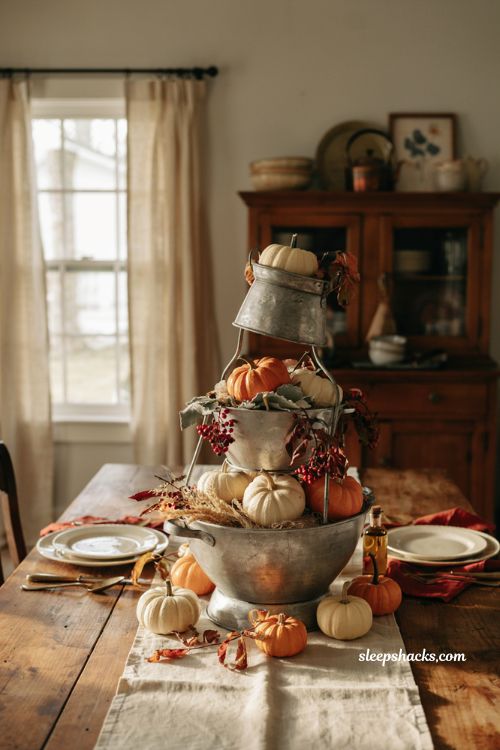 Diy fall centerpieces for table with stacked vintage colanders and pumpkins