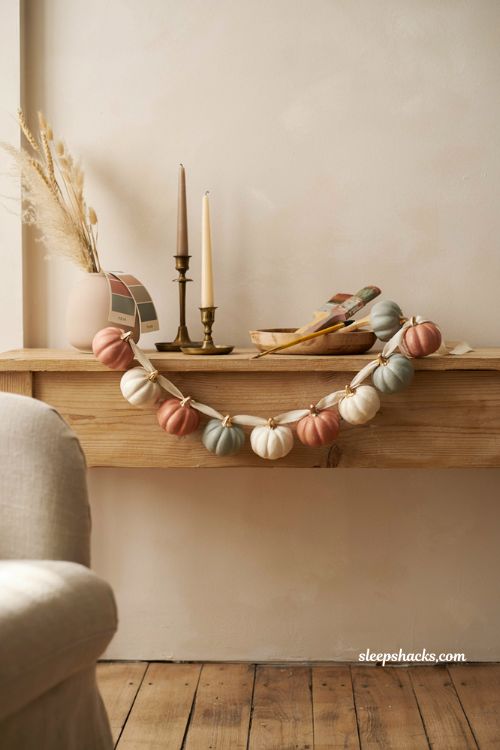Diy mini painted pumpkin garland with muted colors and gold details for fall decor
