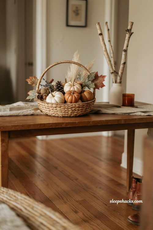 Dollar Tree basket fall decor with mini pumpkins pinecones faux leaves and rustic entryway accents 