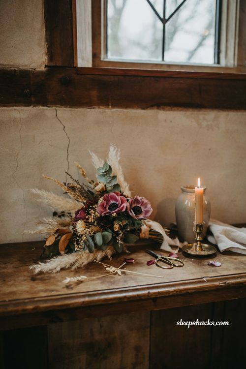 Dried winter wedding bouquet with burgundy anemones pampas grass and eucalyptus