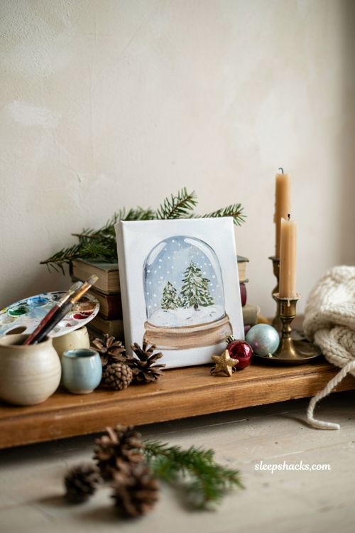 Easy Christmas snow globe painting on canvas with cozy winter shelf decor
