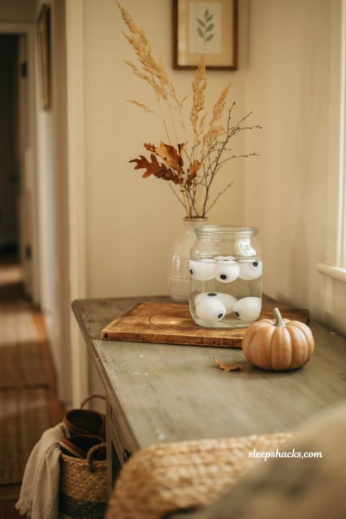 Easy Halloween floating eyeball jar centerpiece with ping pong ball eyes and cozy entryway decor