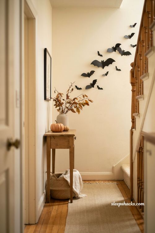 Easy Halloween paper bat wall decor with handmade flying bats in a cozy entryway