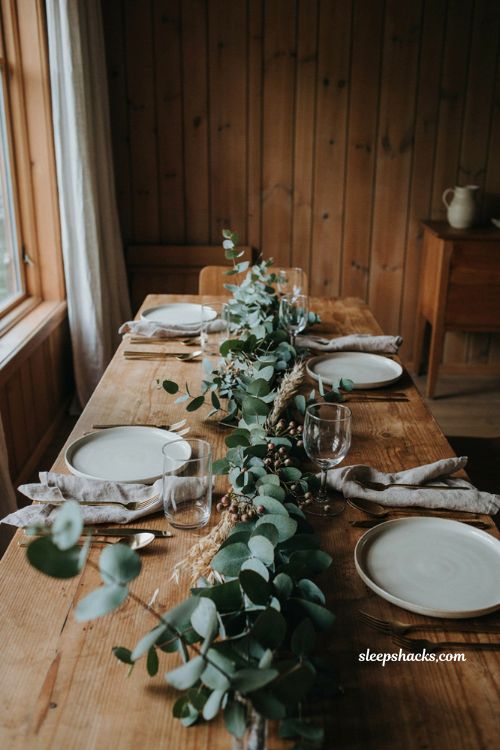 Eucalyptus Thanksgiving table garland with natural greenery dried wheat linen napkins and rustic autumn table decor 