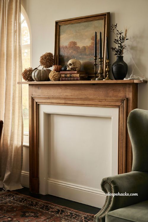 Fall Halloween decor with pumpkins dried florals vintage books and subtle gothic accents