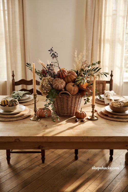 Fall basket centerpiece with heirloom gourds greenery and rustic dining table