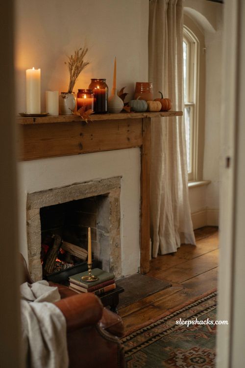 Fall candle ideas with cozy autumn mantel decor and warm candlelight