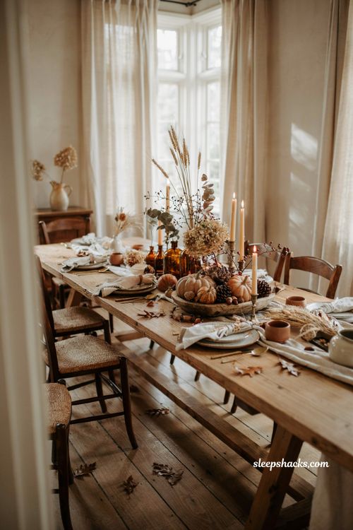 Fall centerpiece ideas with heirloom pumpkins dried flowers and rustic dining table