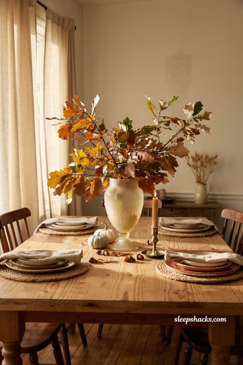 Fall centerpiece with antique milk glass vase oak leaves and brass candlestick