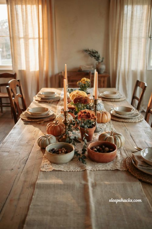 Fall centerpiece with layered table runners flowers and heirloom pumpkins
