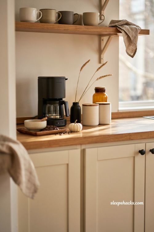 Fall coffee bar decor ideas with neutral coffee cabinet cream mugs warm wood and simple accents 