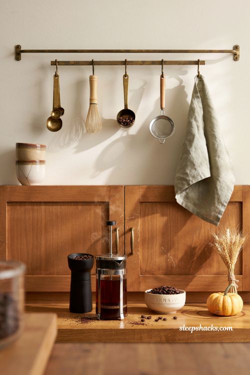 Fall coffee bar decor ideas with wall rail storage coffee tools wood cabinet and cozy accents 