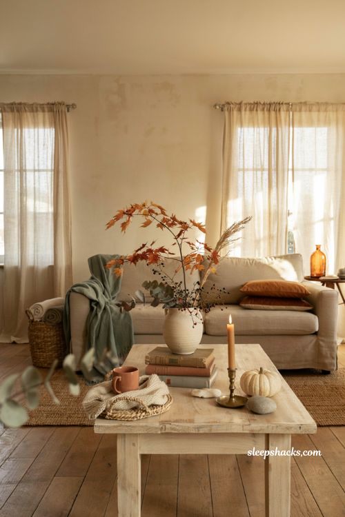 Fall coffee table centerpiece with stacked vintage books vase and candle