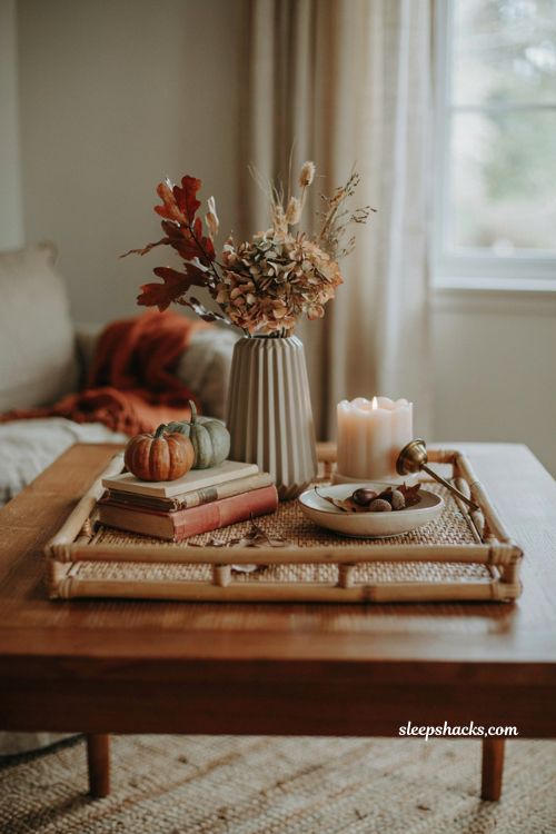 Fall coffee table decor with brass candle snuffer candle and cozy autumn styling 