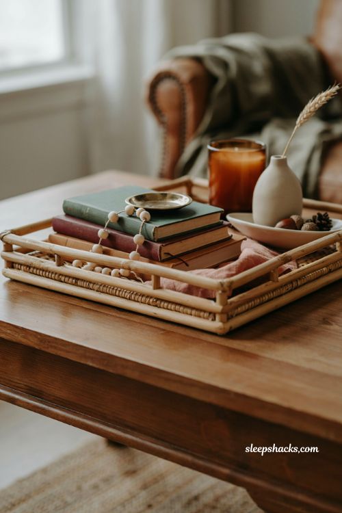 Fall coffee table decor with round gold dish books and curved accents 