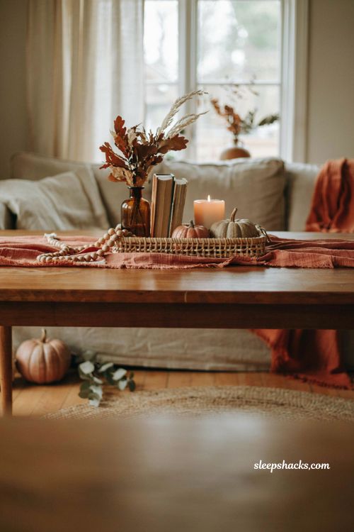 Fall coffee table decor with rust table runner wooden bead garland and tray 