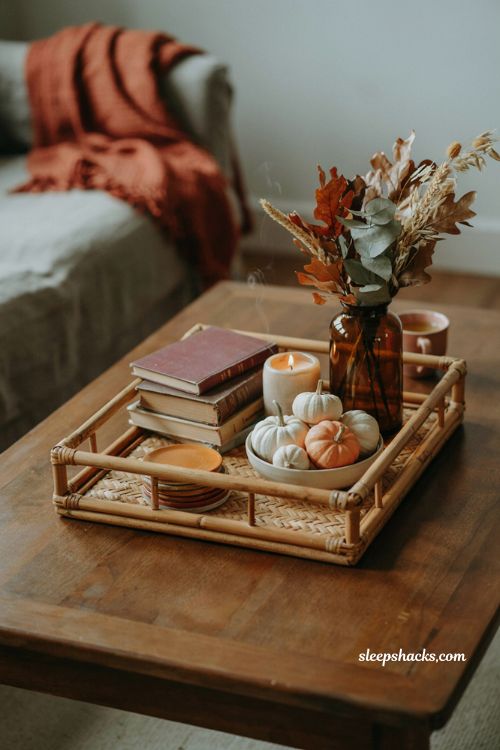 Fall coffee table decor with woven coasters pumpkins books and autumn accents 