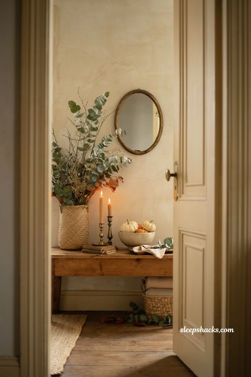 Fall entryway table decor with cascading stems in woven basket and cozy accents