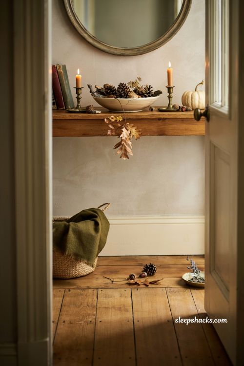 Fall entryway table decor with pinecones acorns twigs and natural centerpiece