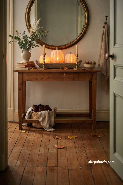 Fall entryway table decor with pre lit pumpkins warm glow candles and rustic accents
