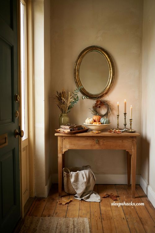 Fall entryway table decor with pumpkins candles wreath and cozy farmhouse accents