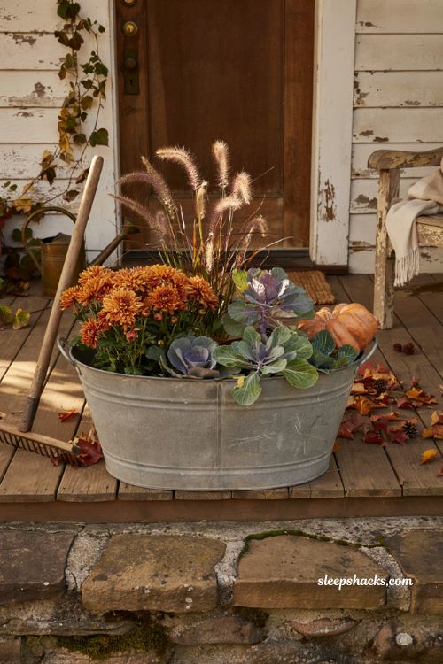 Fall flower pot in galvanized tub with fountain grass and mums for farmhouse porch