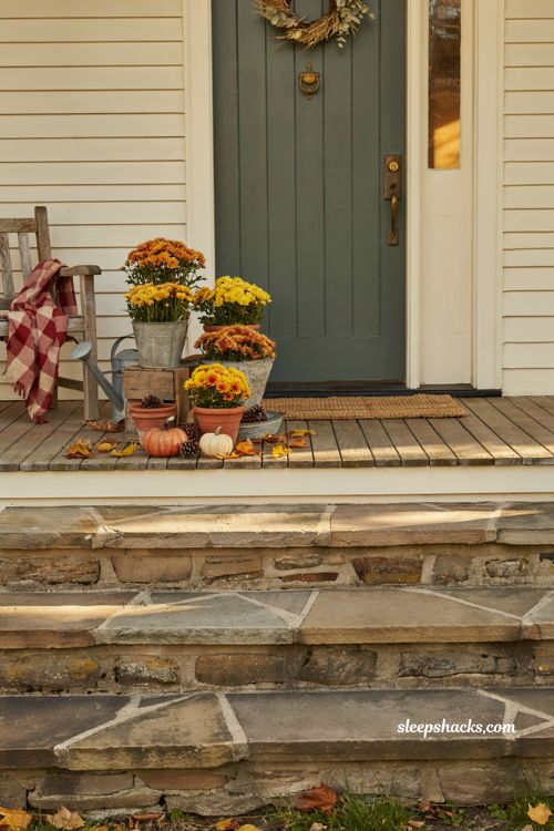 Fall flower pots with grouped orange and yellow mums for front porch