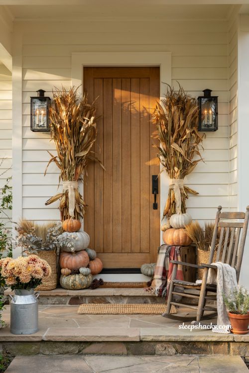 Fall front porch decor ideas with bundled corn stalks pumpkins and farmhouse charm