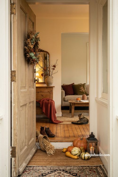 Fall house decor with cozy entryway porch pumpkins warm lighting dried wreath and autumn accents