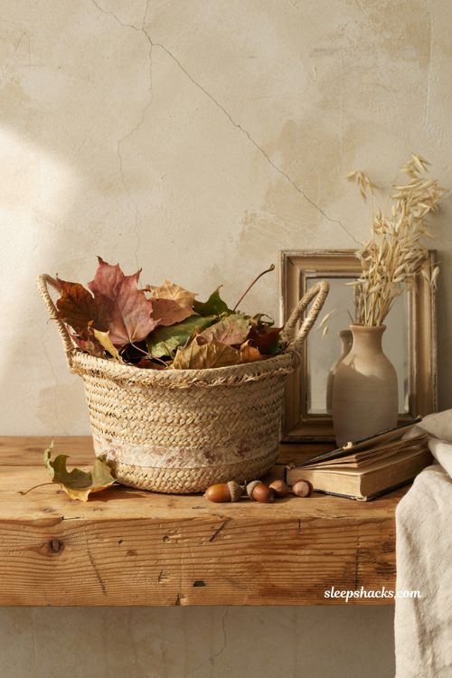 Fall leaves decor in a vintage woven basket with acorns